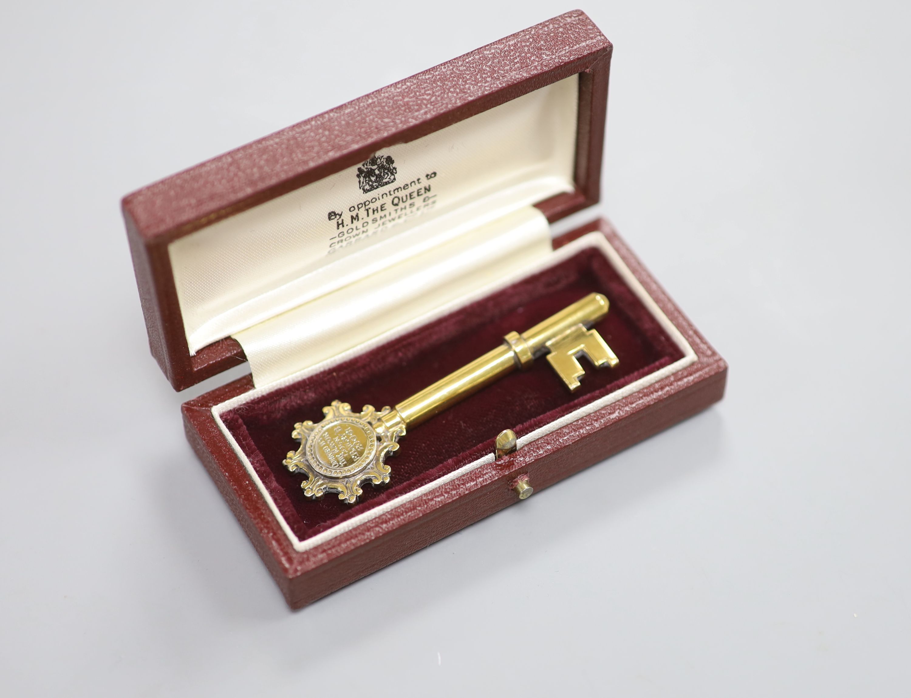 A modern silver gilt presentation key, Birmingham, 1961, 67mm, with engraved inscription.